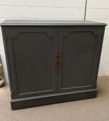 A painted two door cupboard opening to drawers inside (H85cm W97cm D42cm)