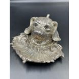 A silver plated dogs head inkwell with glass inset eyes