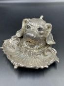 A silver plated dogs head inkwell with glass inset eyes