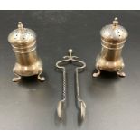 A pair of silver sugar nips by AJB and two silver pepper pots