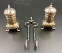 A pair of silver sugar nips by AJB and two silver pepper pots