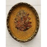 A gilt oval framed needle work 57cm x 50cm