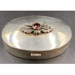 A silver pill box, with floral motif to lid