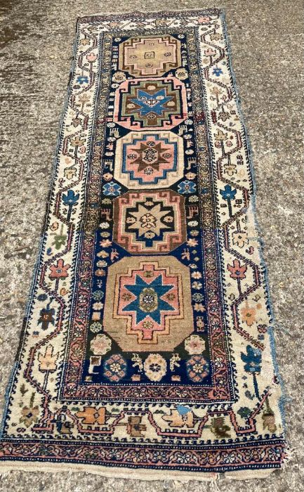 A Blue ground runner with geometric border and star centre (275cm x 98cm)