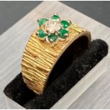 An 18ct gold ring with diamonds and emerald with bark style effect band (5.9g) (Size M)