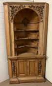 A Victorian carved pine corner cabinet with architectural doomed top and applied carved