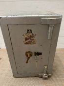 A metal safe with key (H63cm W40cm)