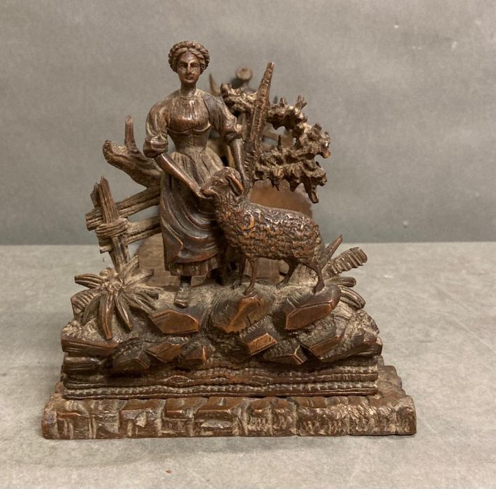 A pair of ornate hand carved adjustable book ends of a pastoral scene
