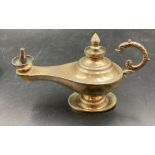 A silver small Aladdin's style lamp, approximately 13cm in length.