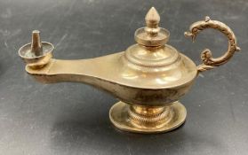 A silver small Aladdin's style lamp, approximately 13cm in length.