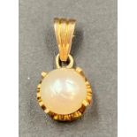 A pearl and gold pendant