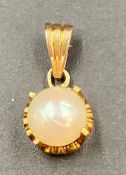 A pearl and gold pendant