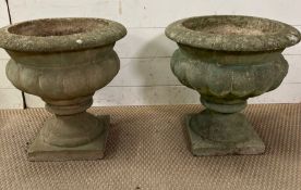 A pair of reclaimed urns on square bases