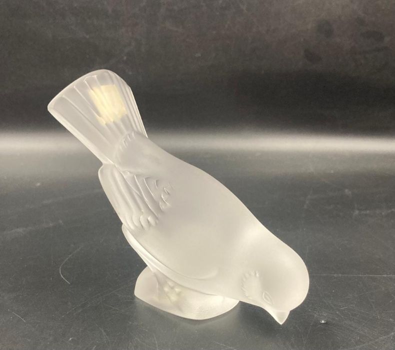 A Lalique crystal paperweight in the form of a bird.