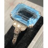 An aquamarine and diamond ring set on a platinum shank, central stone is approx 3 cts. with