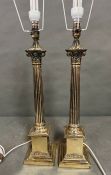 A pair of Corinthian column brass lamps