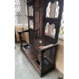 Jacobean style oak hall stand with central bevelled edge mirror, four cut out panels with metal coat