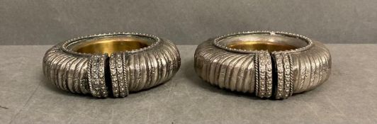 A pair of white metal African bracelets converted to ash trays