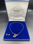 A 9ct gold necklace with pearl pendant and matching earrings