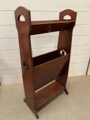 An Arts and Crafts bookcase with cut out decoration to side (87cm x 43.5cm)