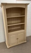 An open front bookcase with cupboard under (H196cm W118cm D54cm)