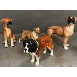Four ceramic figures of dogs, two stamped Beswick