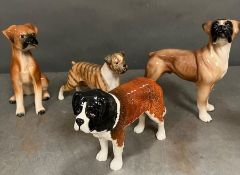 Four ceramic figures of dogs, two stamped Beswick