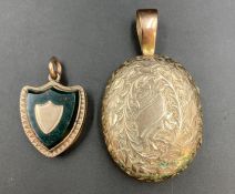 Two silver lockets, one shield shaped