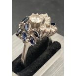 A sapphire and diamond cocktail ring set in 18ct white gold, Main diamond weighing approx 0.6cts I/J