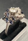 A sapphire and diamond cocktail ring set in 18ct white gold, Main diamond weighing approx 0.6cts I/J