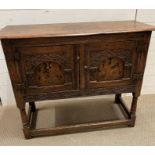 A carved oak side cupboard (H76cm W93cm D39cm)