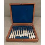 A boxed set, six place setting, mother of pearl and silver fruit knives and forks, hallmarked for