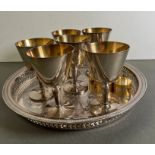 Six silverplate goblets on a tray with six napkin rings