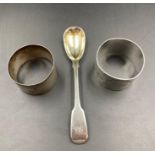 Two hallmarked silver napkin rings and a silver spoon.