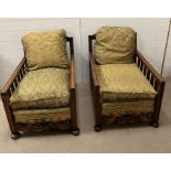 A Victorian salon suite, two gentleman armchairs with scrolling carved fronts and spindled arm