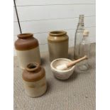 Three stoneware jars and two vintage glass bottles