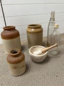 Three stoneware jars and two vintage glass bottles