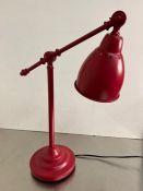 A red Ikea desk lamp