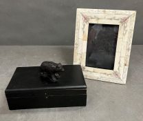 A wooden box with a bronze style bear to top and a decorative photo frame AF