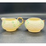A Belleek basket weave and Shamrock cream jug and sugar bowl