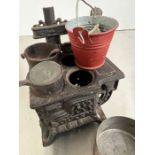 A dolls house metal cooker and fire buckets