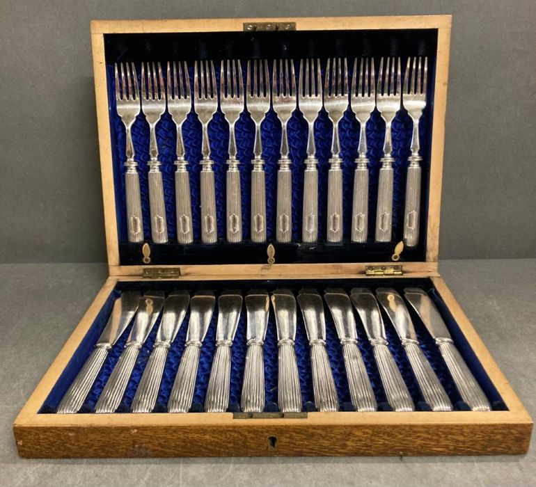 A Twelve place setting silver plate fish knives and forks canteen.