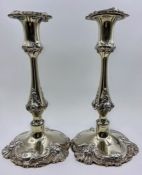 A pair of silver plated, weighted single candlesticks