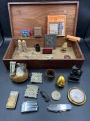 A wooden box with a lovely selection of curio to include Coats of Arms coins, lighters etc