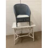A cane painted table and Lloyd Loom chair