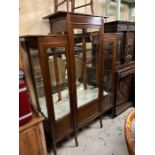 A mahogany display cabinet with glazed front and side and mirrored back