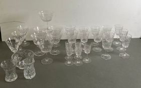 A selection of cut glass and engraved crystal glasses along with bowls