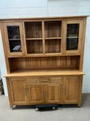 An oak dresser with glazed cabinets and drawers and cupboards under (H182cm W162cm D45cm)