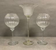 A selection of three tall stemmed glass tea light holders