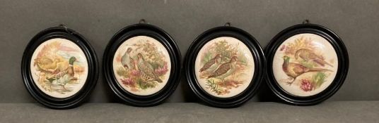 Four framed ceramic pot lids featuring pheasant and partridge